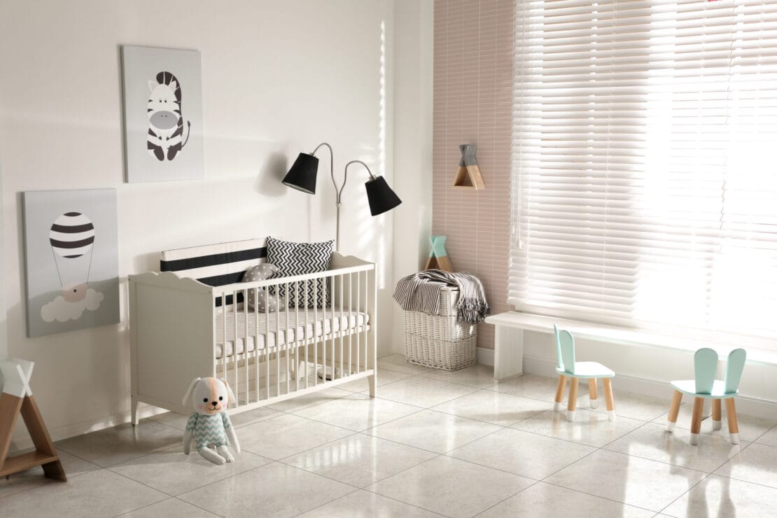 Cute baby room interior with crib and decor elements